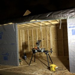 Garden pod installation work being carried out at night showing breather membranes