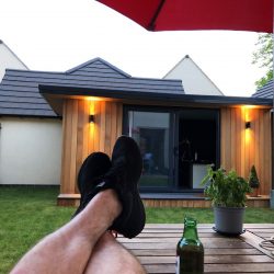 Vivid Pods, Garden Pod finished installation of garden studio relaxing with a beer